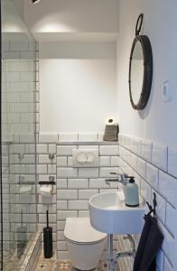 a bathroom with a white toilet and a sink at Studio apartman Knežija in Zagreb