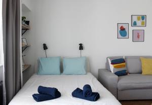 a bedroom with a bed and a couch at Studio apartman Knežija in Zagreb