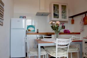 a kitchen with a table and chairs and a refrigerator at Villa Antonini in Lerici