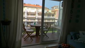 a room with a balcony with a table and a window at Casa Triadors in Sant Antoni de Calonge