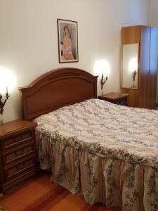 a bedroom with a large bed and two night stands at CA' di ROSE B&B VENICE in Venice