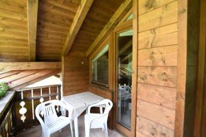 a porch with a table and chairs on a cabin at Boarhof Appartaments in San Giacomo Val di Vizze +26 photos