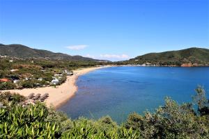 a view of a beach with chairs and the ocean at Villa Manuela in Lacona