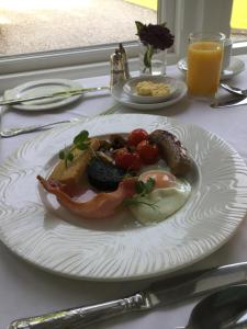 a plate of food on a table at Lyzzick Hall Hotel in Keswick