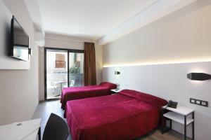 Tempat tidur dalam kamar di Hotel Alameda
