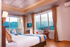 a bedroom with two beds and a large window at Hotel Lake Paradise in Pokhara