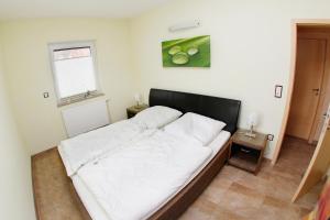 Postel nebo postele na pokoji v ubytování Ferienhaus "Zur Sprotte" in Glowe