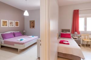 Postel nebo postele na pokoji v ubytování Skandalakis Homes & Apartments
