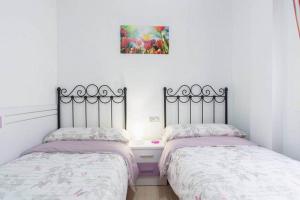 Posteľ alebo postele v izbe v ubytovaní Apartamento Violeta Centro Parking Privado