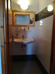 a bathroom with a sink and a mirror at Oasis Hotel Loutro in Loutro +66 photos