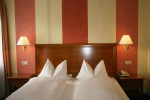 Postel nebo postele na pokoji v ubytování Hotel Wilder Mann