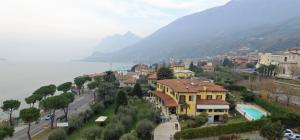 a town on a hill next to a body of water at Villa Kinzica in Sale Marasino