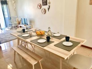 a wooden table with a bowl of fruit on it at Nazaré Beach Apartments in Nazaré
