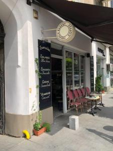 a restaurant with a table and chairs in front of it at Bucharest Victoria Apartment in Bucharest