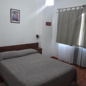 Postel nebo postele na pokoji v ubytování Residencial Ski