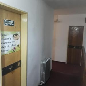 a hallway with a sign on the door of a building at Residencial Ski in Esquel