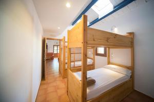 two bunk beds in a room with a ceiling at Crux Albergue in Adahuesca