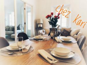 a dining room table with plates and wine glasses at Chez Kari-top location in charming old town in Nice