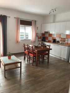 a kitchen and dining room with a table and chairs at Zesty Orange by ITHOUSE in Albufeira