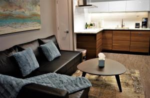 a living room with a couch and a table at Simply Luxury Stays in Ottawa