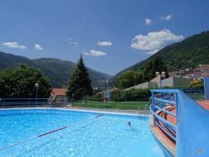 a large swimming pool with mountains in the background at Casa de Manteigas in Manteigas