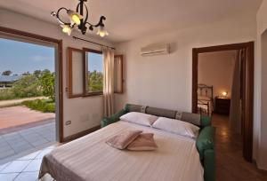 Postel nebo postele na pokoji v ubytování Agriturismo Sa Suerera