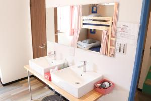 a bathroom with a sink and a bunk bed at Guest House Matsu in Osaka +33 photos