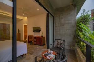 a bedroom with a bed and a table and a chair at Silver Urban in Siem Reap