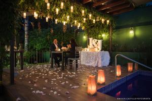 two people are sitting at a table in a restaurant at Las Magnolias Hotel Boutique in San Salvador +226 photos