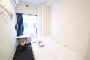 Ένα ή περισσότερα κρεβάτια σε δωμάτιο στο Sakura Hotel Jimbocho