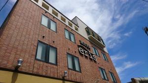 a brick building with a sign on the side of it at Hotel Eris Hakata (Love Hotel) in Fukuoka
