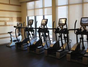 a gym with several tread machines in a room at Luxury condo on CN TOWER in Toronto