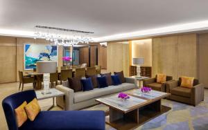 a living room with a couch and chairs and tables at Hyatt Regency Riyadh Olaya in Riyadh