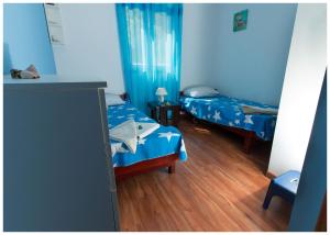 Postel nebo postele na pokoji v ubytování Apartments FRAGOLINA