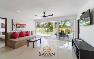 a living room with a couch and a table at SAWAN Residence Pool Villas in Lamai