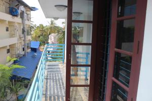 an open door to the balcony of a building at Puthenchirayil Homestay in Trivandrum +12 photos
