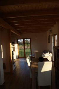 a kitchen and living room with a table and chairs at Lavender Cottage in Charzykowy +16 photos
