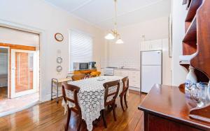 a kitchen and dining room with a table and chairs at Azile 1875 Heritage Victorian Duplex in Grafton