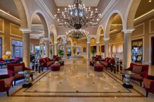 a large lobby with chairs and a chandelier at Jaz Mirabel Resort in Sharm El Sheikh