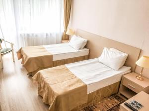 ソロチャにあるSanotoriy Solotchaのベッド2台と窓が備わるホテルルームです。