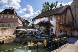 a building next to a river in a city at Chez Sophie in Dole