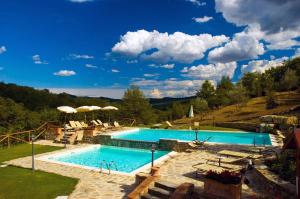a pool with a pool table and chairs in it at Hotel Le Pozze Di Lecchi in Gaiole in Chianti