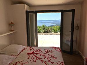 a bedroom with a bed and a large sliding glass door at Santa Rosa in Les Issambres +27 photos