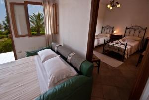 Postel nebo postele na pokoji v ubytování Agriturismo Sa Suerera
