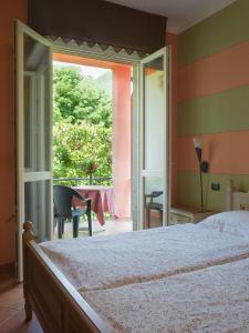 a bedroom with a bed and a sliding glass door at Casa Ponte Ballerino in Cannobio