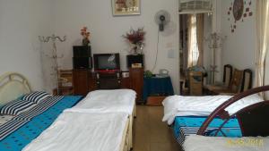 Giường trong phòng chung tại Homstay An Nhien