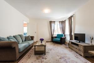 a living room with a couch and a tv at Lahe apartment in Haapsalu