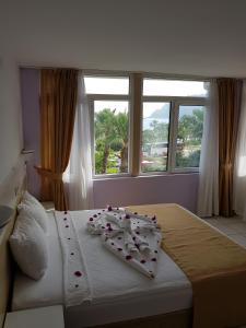 a bedroom with a bed with roses on it at Resitalya Hotel in Alanya