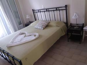 a bedroom with a bed with a robe on it at Pension Gerania in Asos