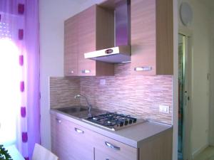a kitchen with a sink and a stove top at Cà Bianca in Bibione
